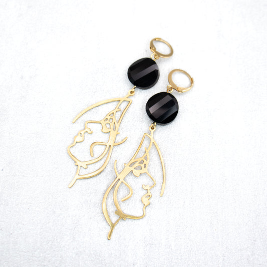 Black beads with gold face charms. Handmade earrings.