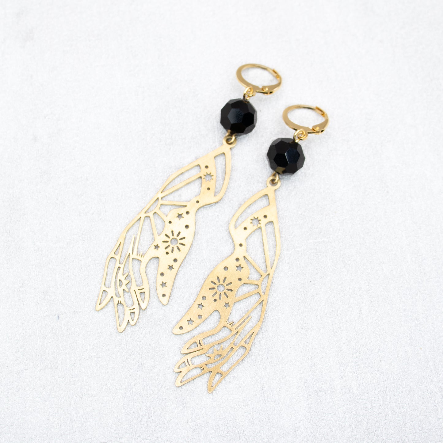 Black beads with gold hand charms. Handmade earrings.